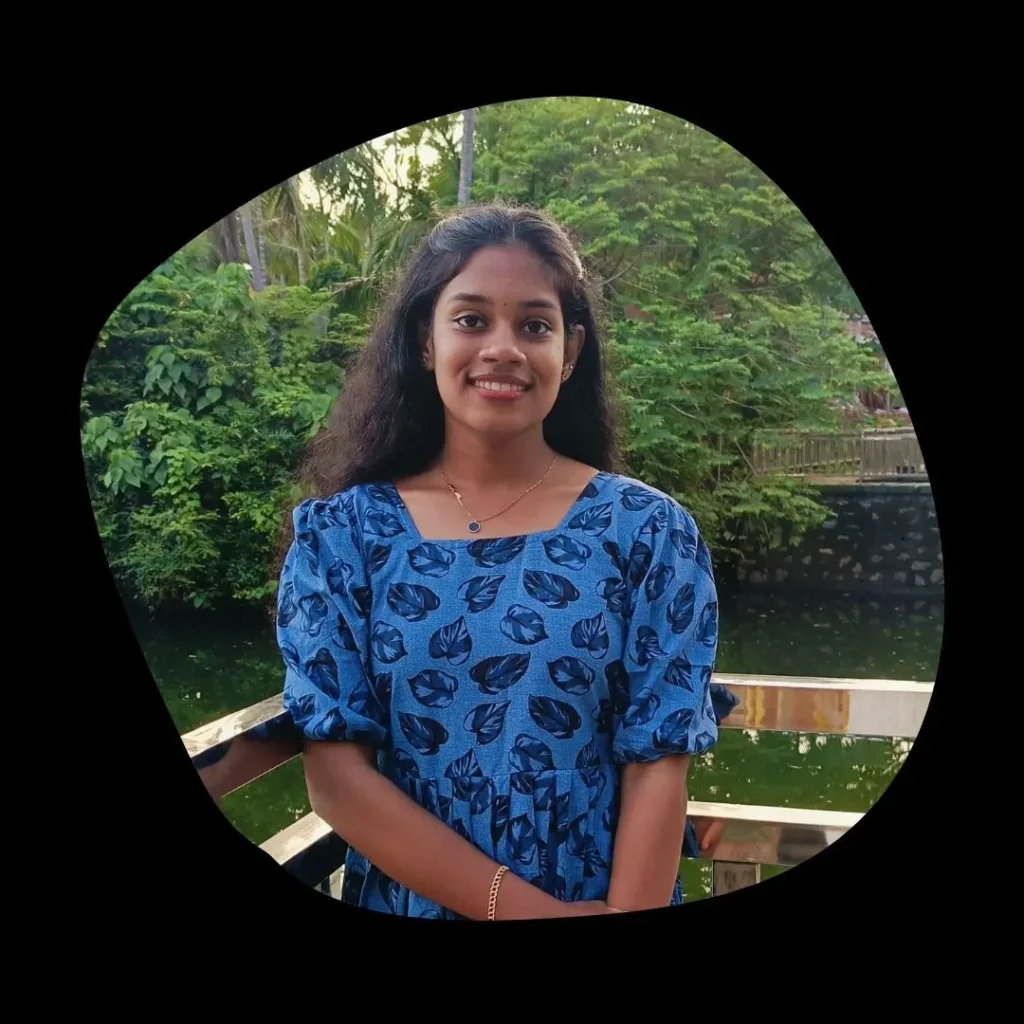 Anjana Sunil, best freelance digital marketing consultant in Kannur, smiling outdoors near lush greenery